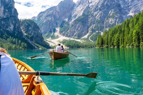 Tourists enjoying a boat trip on the stunning lake braies, surrounded by the breathtaking scenery