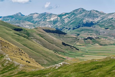Mountain landscape on the edge of the Pian Grande di Castelluccio di Norcia plateau in the Monti