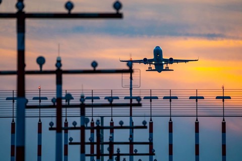 Runway lighting, approach aids, at Düsseldorf International Airport, sunset, aircraft taking off