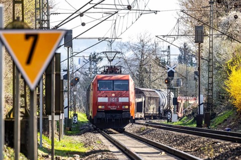 Goods train with a Deutsche Bahn AG locomotive travelling on the open track. Stuttgart,