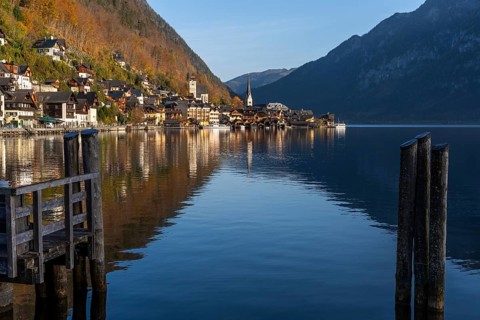 View of Hallstatt and Lake Hallstatt. In the morning in autumn. Good weather, blue sky. Reflection.