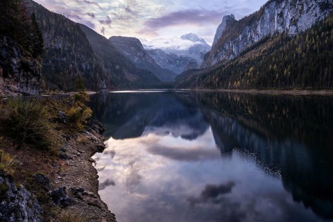 The Vordere Gosausee lake in the morning in autumn with a view of the Dachstein mountain range. The