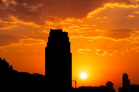 The sun sets behind the Mainplaza Hotel in Frankfurt am Main, Frankfurt am Main, Hesse, Germany,