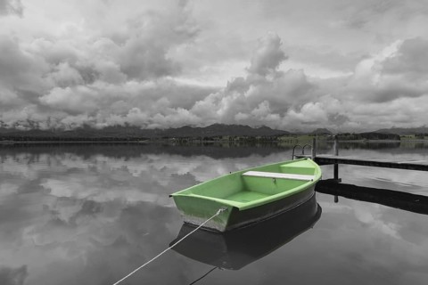 Storm clouds at sunset, a green rowing boat lashed to the wooden jetty, Hopfensee, Hopfen am See,