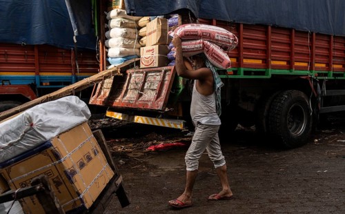 GUWAHATI, INDIA - MAY 1: Labourers carries goods in a wholesale market, in Guwahati, India, on May