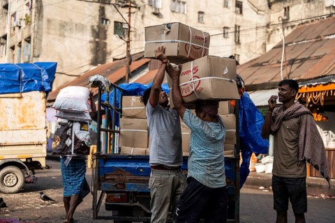 GUWAHATI, INDIA - MAY 1: Labourers carries goods in a wholesale market, in Guwahati, India, on May