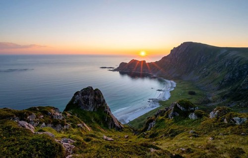 View of coastal landscape at sunset, cliffs and summit of Måtind or Måtinden, Høyvika beach and