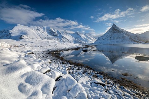 Snowy landscape with mountains and fjord, Volandstinden mountain, Fredvang, Flakstadøya, Lofoten,