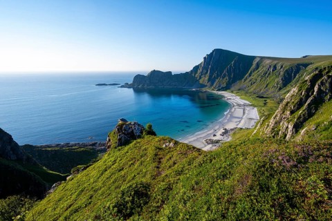 View of coastal landscape, cliffs with peak Måtind or Måtinden, Høyvika beach and sea, hike to the