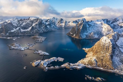 View of islands, fjord and mountains, snow-covered landscapeFishing villages Hamnøy, Sakrisøy and