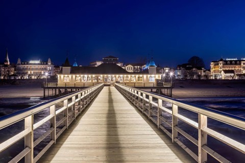 Restaurant on Ahlbeck Pier, Seebrücke Ahlbeck illuminated at dusk in the Baltic Sea on Usedom