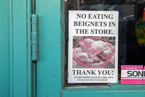 New Orleans, Louisiana - A sign in a store in the French Market asks visitors not to eat beignets