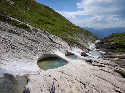 Glacier mill with glacier pots on the Trinser Alp Mora, Trin, Canton Graubünden, Switzerland,