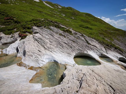 Glacier mill with glacier pots on the Trinser Alp Mora, Trin, Canton Graubünden, Switzerland,