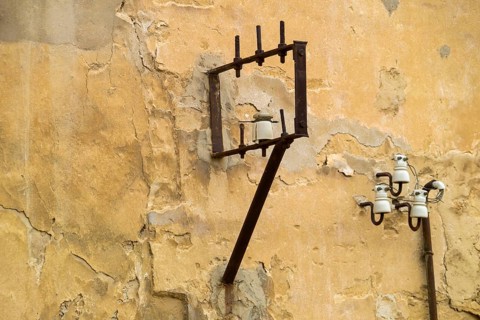 Power lines on a house wall with ceramic insulators, Agrigento, Agrigento, Sicily, Italy, Europe