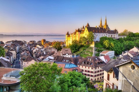 Neuchâtel Castle with view over the town of Neuchâtel at sunrise, behind it Lake Neuchâtel, Canton