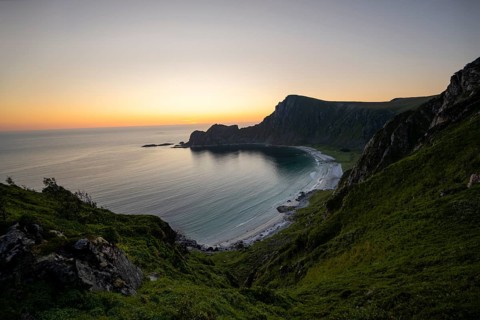 View of coastal landscape at sunset, cliffs and summit of Måtind or Måtinden, Høyvika beach and