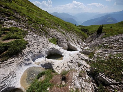 Glacier mill with glacier pots on the Trinser Alp Mora, Trin, Canton Graubünden, Switzerland,