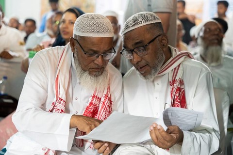 Hajj pilgrims check passport and documents before leaving to the airport, in Guwahati, India on 3