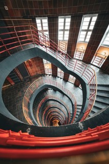 Dramatic spiral staircase with red banisters and windows, SPRINKENHOF, Hamburg, Germany, Europe