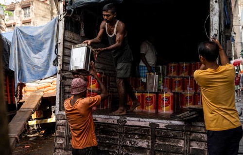 GUWAHATI, INDIA - MAY 1: Labourers carries goods in a wholesale market, in Guwahati, India, on May