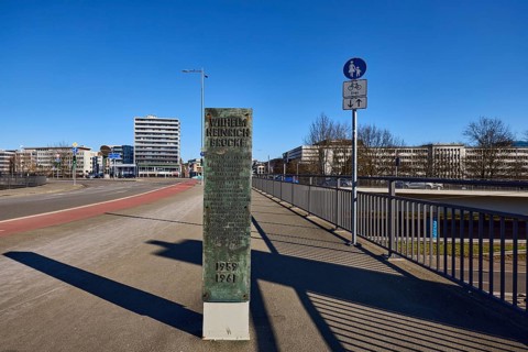 Footpath and cycle path, metal railing, lantern, general architecture, high-rise building, stele