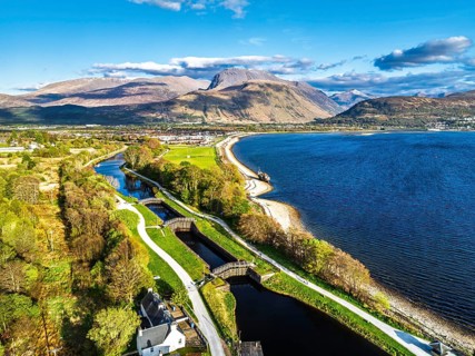 View of Caledonian Canal, Caol Beach and Nevis Range Mountains from a drone, Corpach, Fort William,