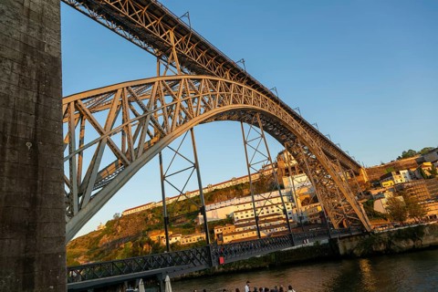 Golden hour at Dom Luis I Bridge crossing River Douro to Vila Nova de Gaia, Porto, Portugal, Europe