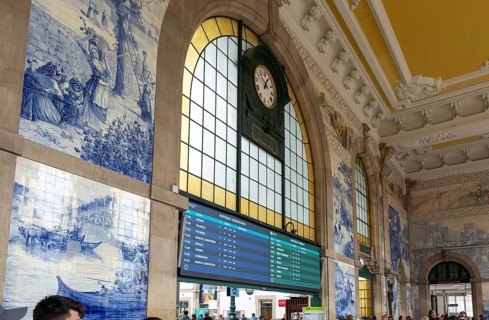Azulejos tiles and clock interior Sao Bento railway station building, city of Porto, Portugal,