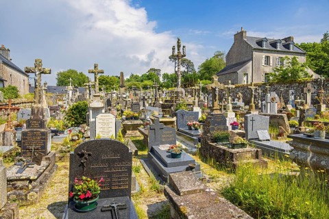 Tombstones in an old cemetery in a French old village, Locronan, Bretagne, France, Europe