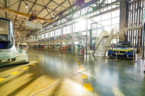 Hall with glass garage full of cars, direct sunlight and modern architecture, Motorworld Böblingen,