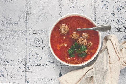 Romanian soup with meatballs, vegetable soup with meatballs, tiled table, homemade, no people