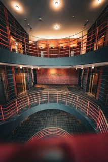 Modern multi-storey staircase with industrial flair and warm lighting, SPRINKENHOF, Hamburg,