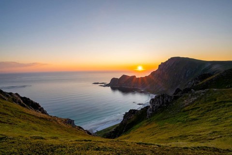 View of coastal landscape at sunset, cliffs and summit of Måtind or Måtinden, Høyvika beach and