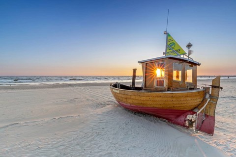 Traditional wooden fishing boat on the beach along the Baltic Sea at Ahlbeck, Heringsdorf on the