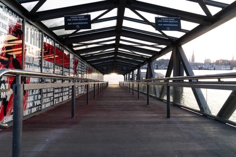 Glass-roofed bridge with a view of the city in the background, The Lion King, Hamburg, Germany,