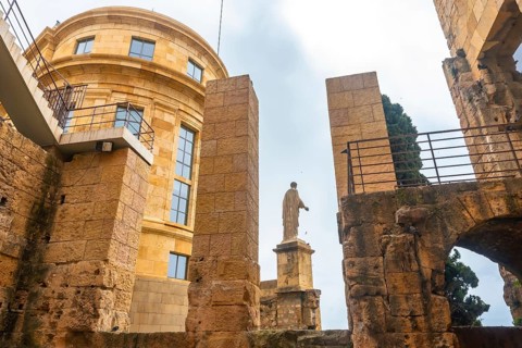 Roman statue standing tall amidst the ruins of tarragona, showcasing the city's rich historical