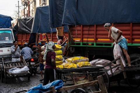 GUWAHATI, INDIA - MAY 1: Labourers carries goods in a wholesale market, in Guwahati, India, on May