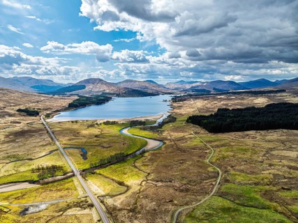 Mountains and Moors over Loch Tulla and River Orchy from a drone, Highlands, Scotland, UK