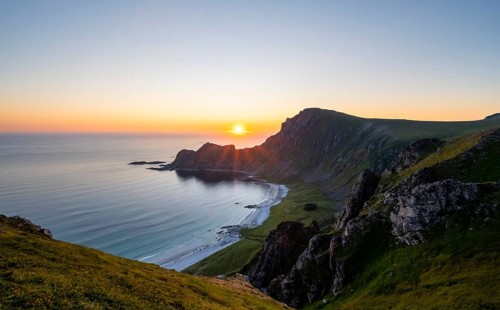 View of coastal landscape at sunset, cliffs and summit of Måtind or Måtinden, Høyvika beach and