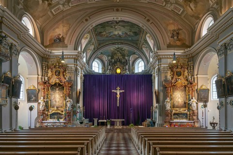 Interior with large purple Lenten cloth in front of the high altar, baroque parish church of St
