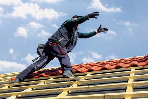 Roofer covering a tiled roof