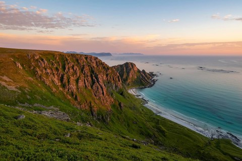 View of coastal landscape at sunset, cliffs, Høyvika beach and sea, hike to the summit of Måtind or