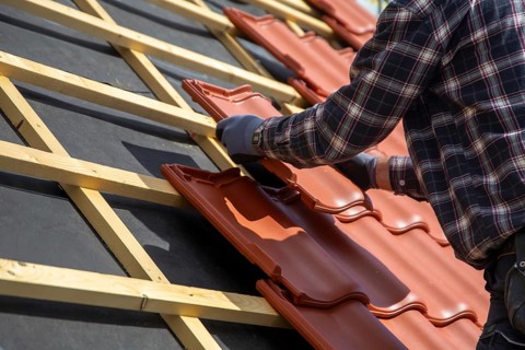 Roofer covering a tiled roof