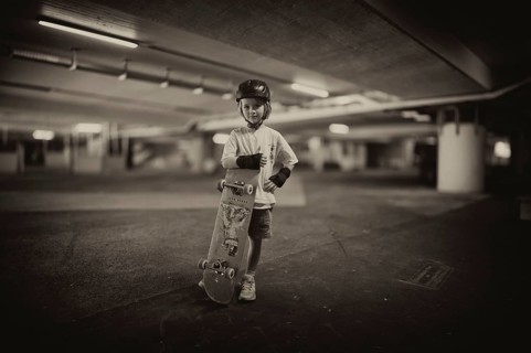 Boy, blonde, 6 years, posing with skateboard, crash helmet, protective clothing, subway, urban,