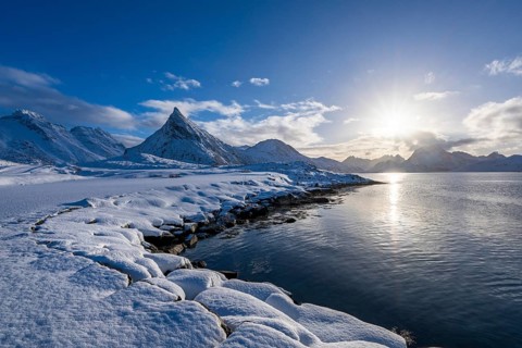 Snowy landscape with mountains and fjord, Volandstinden mountain, Fredvang, Flakstadøya, Lofoten,