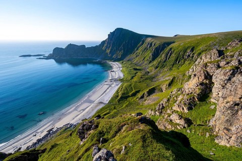 View of coastal landscape, cliffs with peak Måtind or Måtinden, Høyvika beach and sea, hike to the