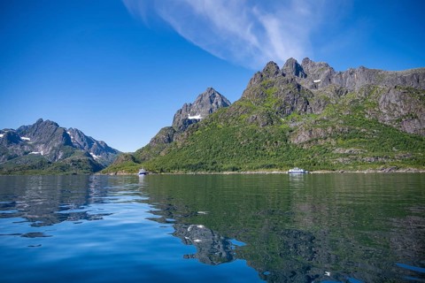 Mountain peaks at Raftsund reflected in the water, fjord landscape with mountains, Lofoten,