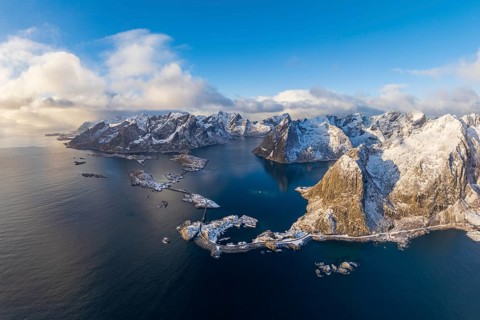 View of islands, fjord and mountains, snowy landscape, fishing villages Hamnøy, Sakrisøy and Reine,