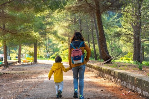 Mother and son enjoying a peaceful walk through the natural beauty of la fontcalda, a sanctuary